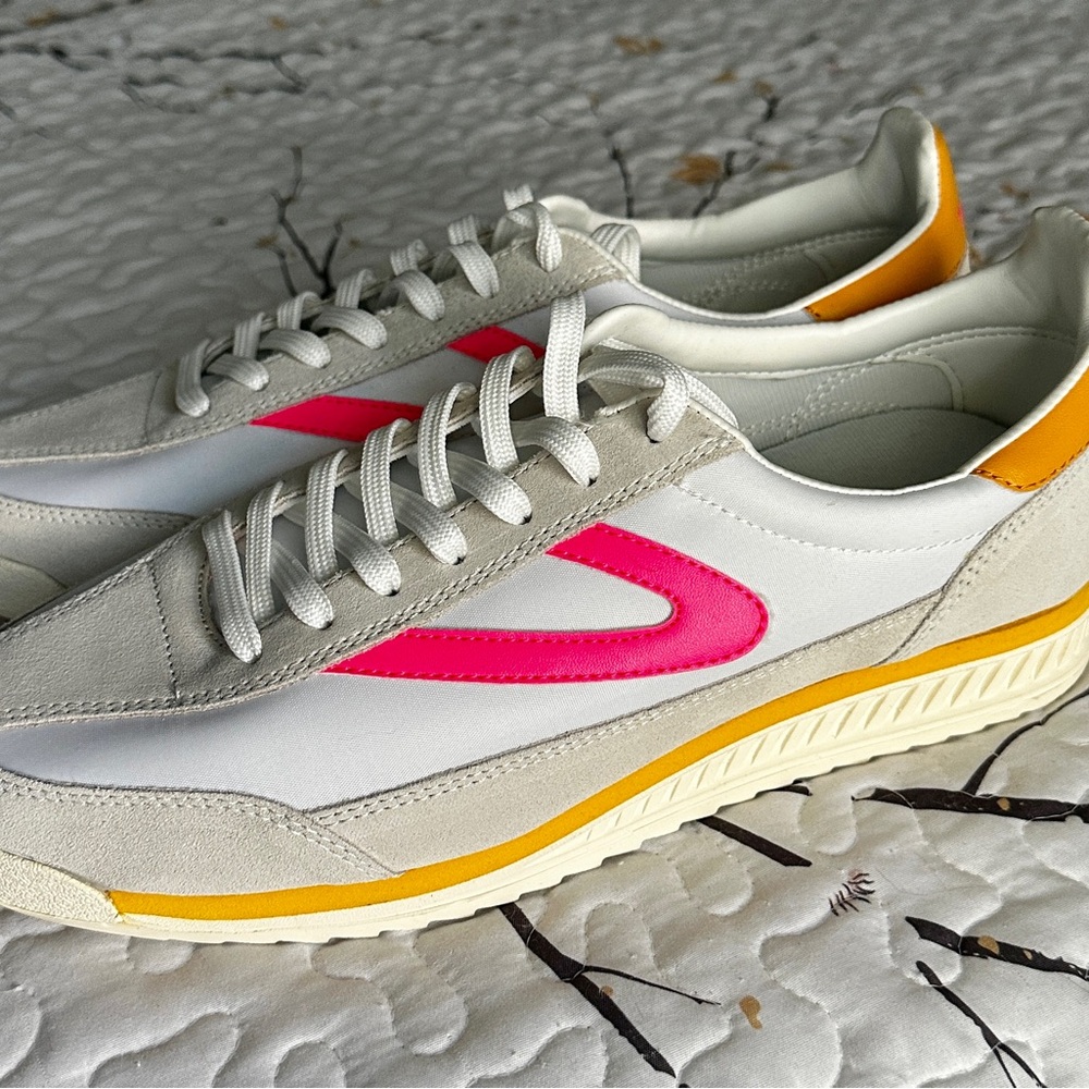 Tretorn sneakers with pink and yellow accents.
